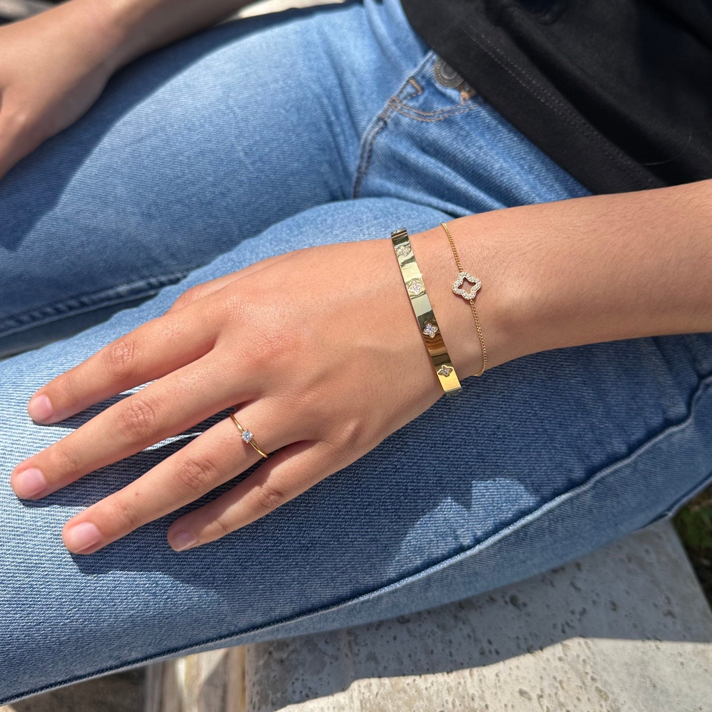 gold trio of solitaire ring, clover chain bracelet, clover bangle