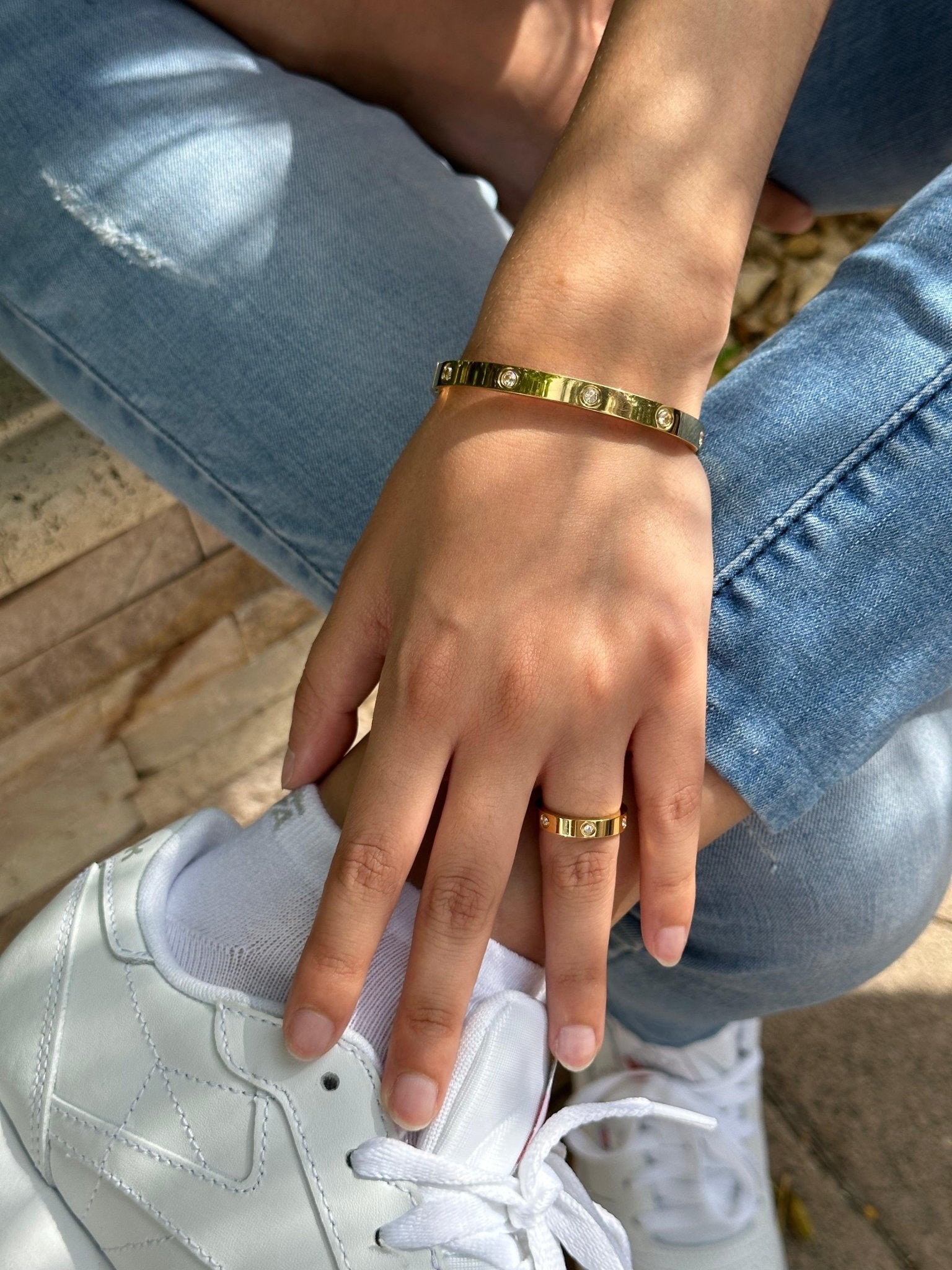gold stone encrusted band and matching bracelet