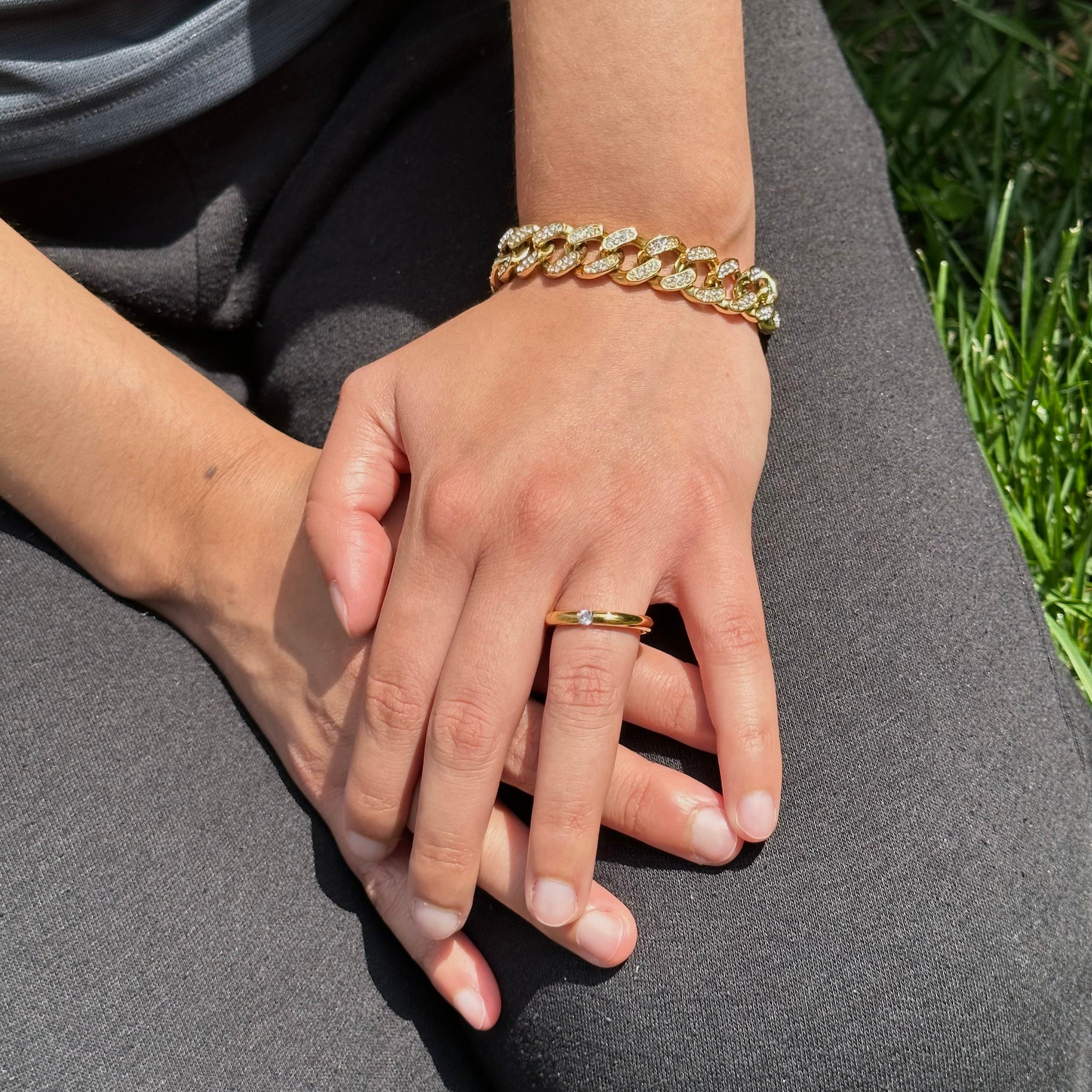 gold iced out bracelet and solitaire ring