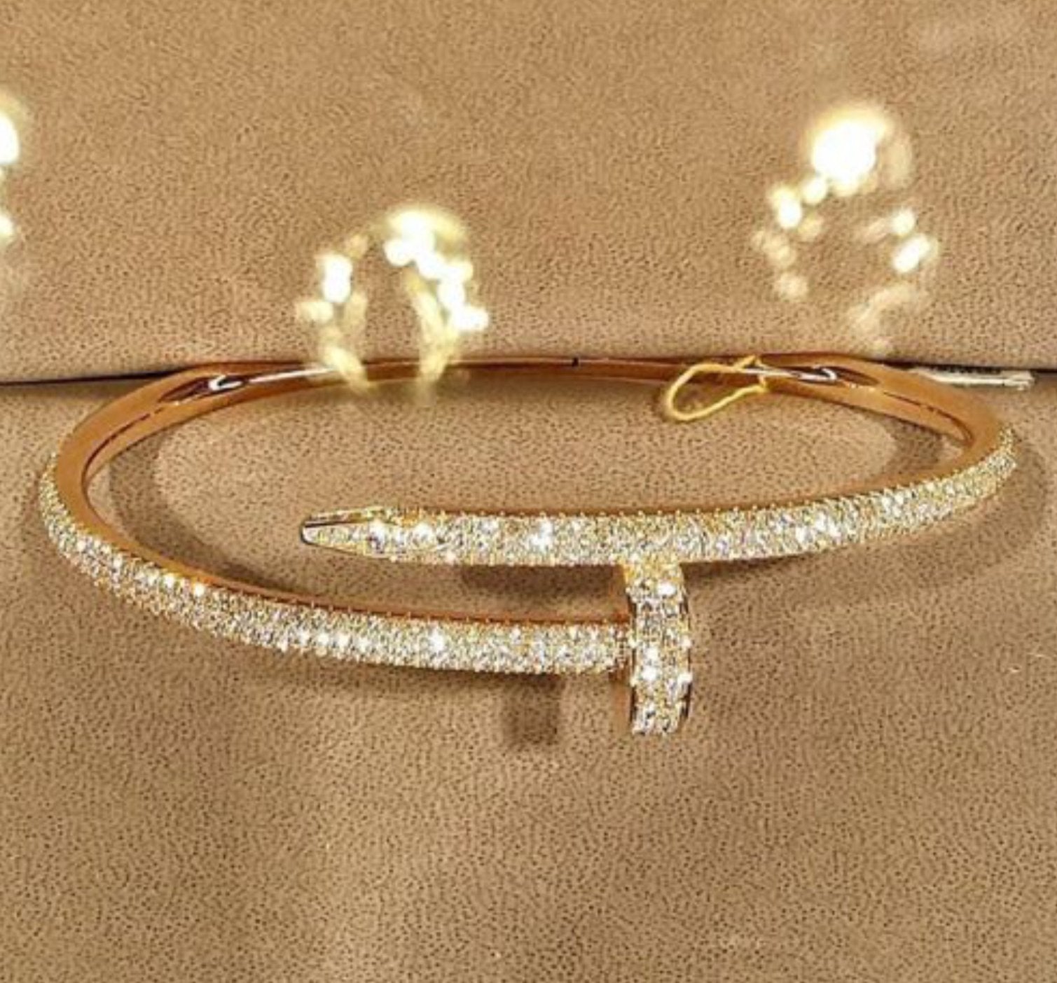 Gold iced out diamond encrusted bangle from 1oaks.com
