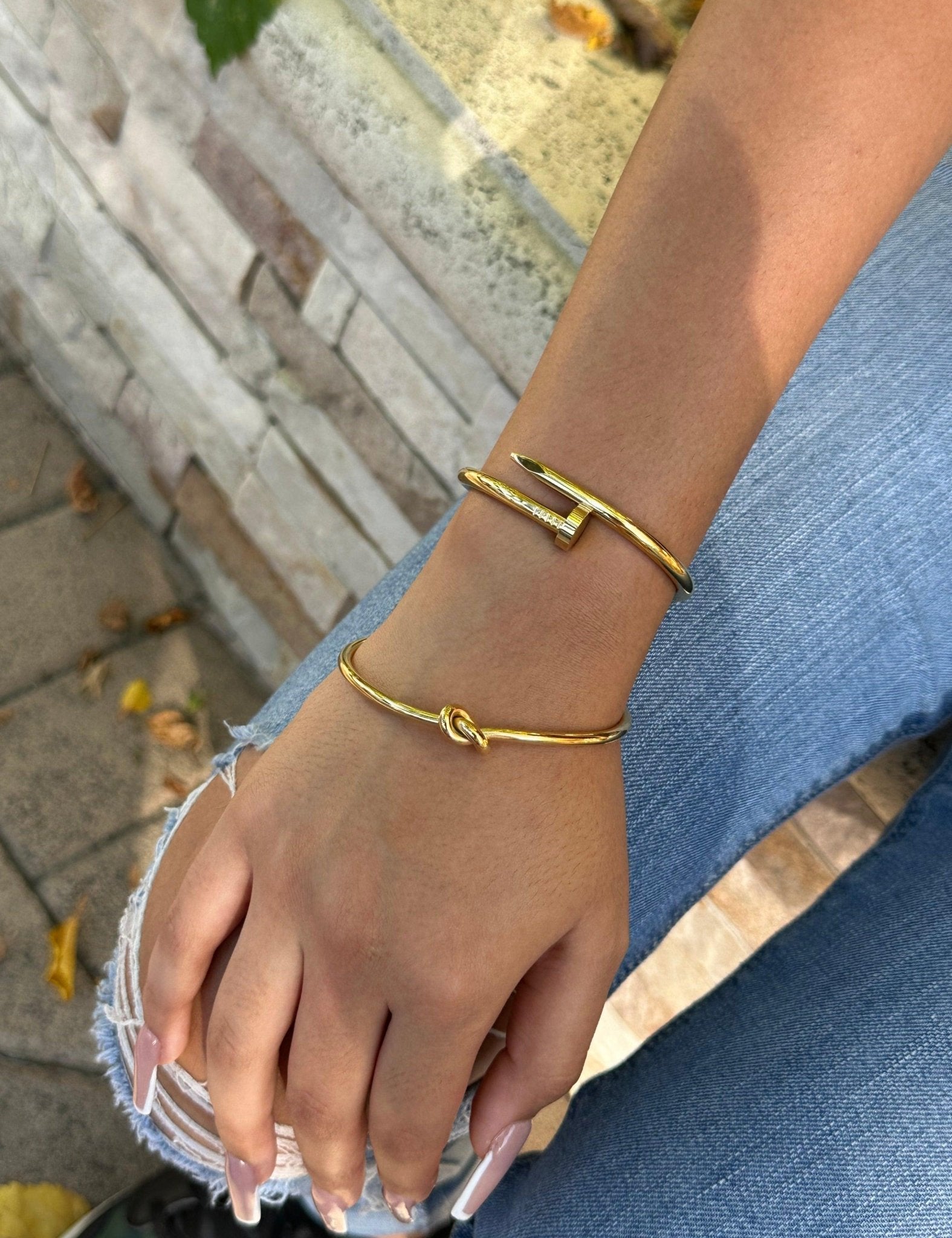 dainty gold knot bracelet and nail bangle stack