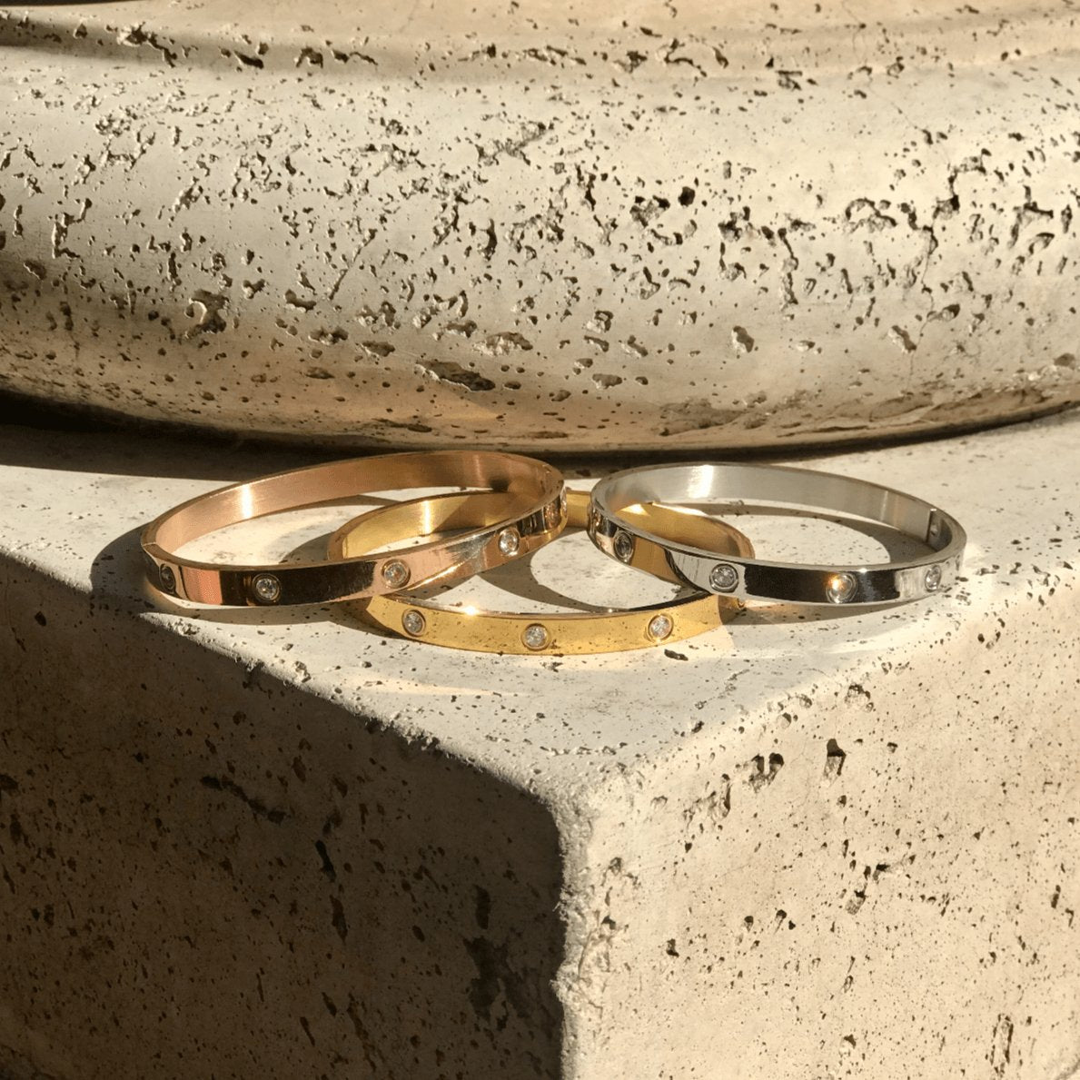 Set of 3 set in stone hinged bracelets in gold silver and rose gold