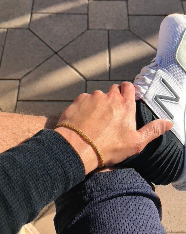 Mens gold chain bracelet and white sneakers look